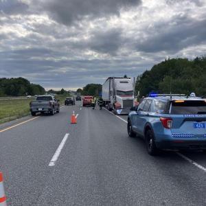 vehicles parked on highway with wrong-way facing tractor trailer truck