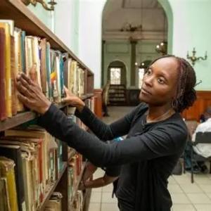 one women looks through a book shelf