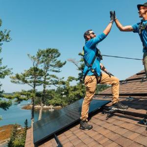 two men on roof hi-five