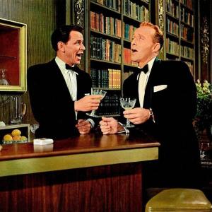 two men sing at bar