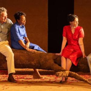 color picture of two men, two women on stage