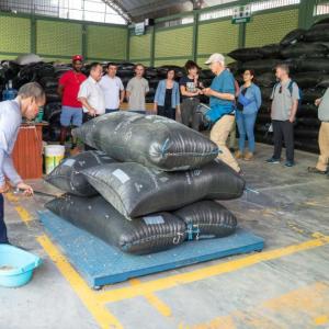 tour group looks at large bags