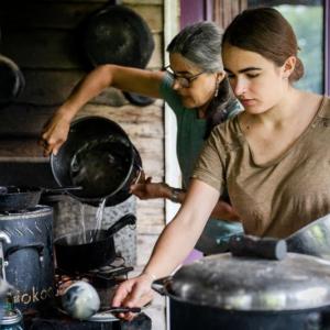 two women handling pots