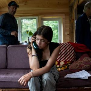 young woman talking on a landline phone.