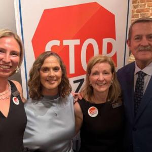 three women, man pose for picture