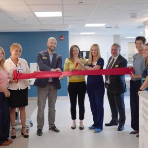 eight adults at ribbon cutting