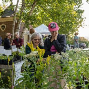 two women look at plants
