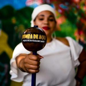 woman holds maraca