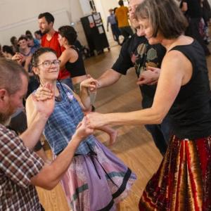 four people in circle dance