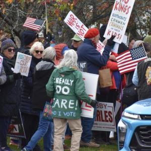 crowd, words on back of green coat