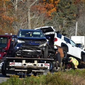 two vehicles loaded on flat beds
