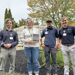 four people in front of garden