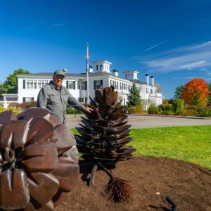 man, sculptures, Blaine House in background