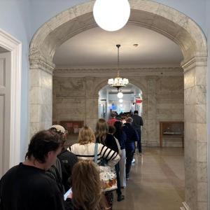 people stand in line to vote.