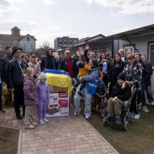 large, multi-generation group poses with donation