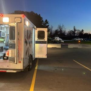 Camden Fire and Rescue and North East Mobile Health Service first responders transfer a cardiac arrest patient from the back of the ambulance to a waiting LifeFlight 