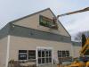 Last touches on the sign for the new Edwards Brothers Supermarket in Searsport. Photo by Kay Stephens