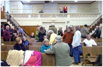 The audience in Searsport's Union Hall during a break in deliberations Wednesday night. (Photo by Ethan Andrews)
